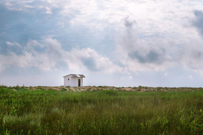 Built structure on field against sky