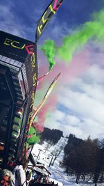 Low angle view of flags against sky