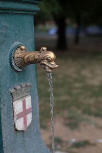 Close-up of faucet against blurred background