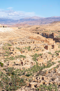 Scenic view of old stone houses, palm trees ghoufi canyon in the aures region, algeria