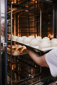 Cropped hands preparing pastry in bakery