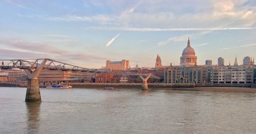 Bridge over river with buildings in background