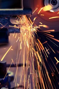 Close-up of sparks emitting from saw