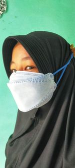 Young muslim girl wearing face mask in new normal rule