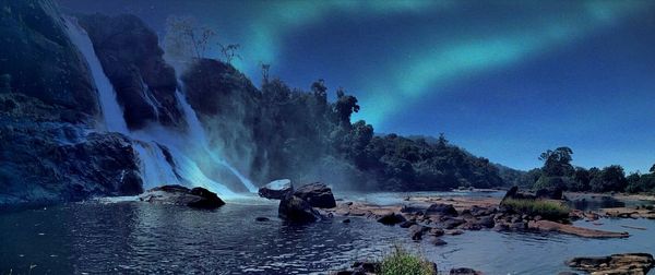 Scenic view of waterfall against sky