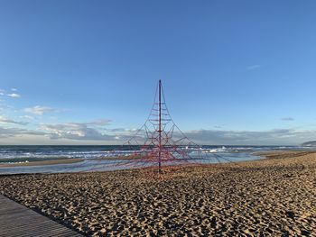 Scenic view of beach against blue sky