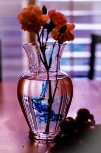 Close-up of flowers in glass vase on table