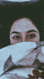 Close-up portrait of young woman in winter