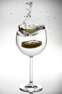 Close-up of wine glass against white background