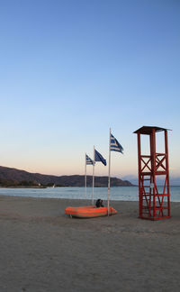 Lifeguard hut on beach against clear sky