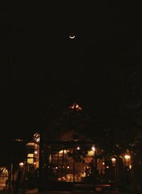 Illuminated buildings against sky at night