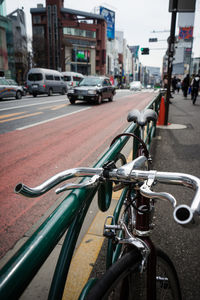 Close-up of bicycle on road in city