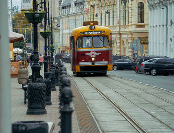 Cars on street by buildings in city