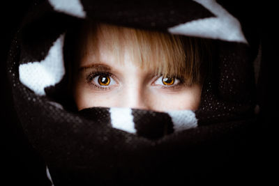 Close-up portrait of teenage girl covering face