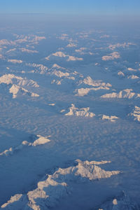 Aerial view of snowcapped mountains against sky