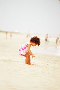 Cute girl bending at beach