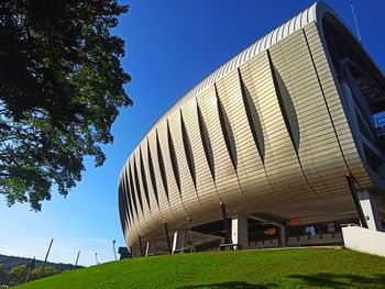 Low angle view of modern building against clear blue sky