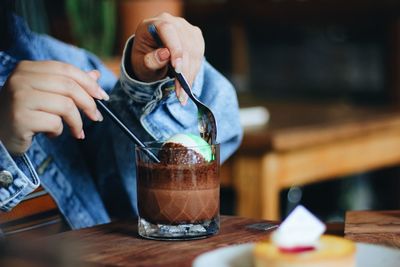 Man holding coffee cup on table