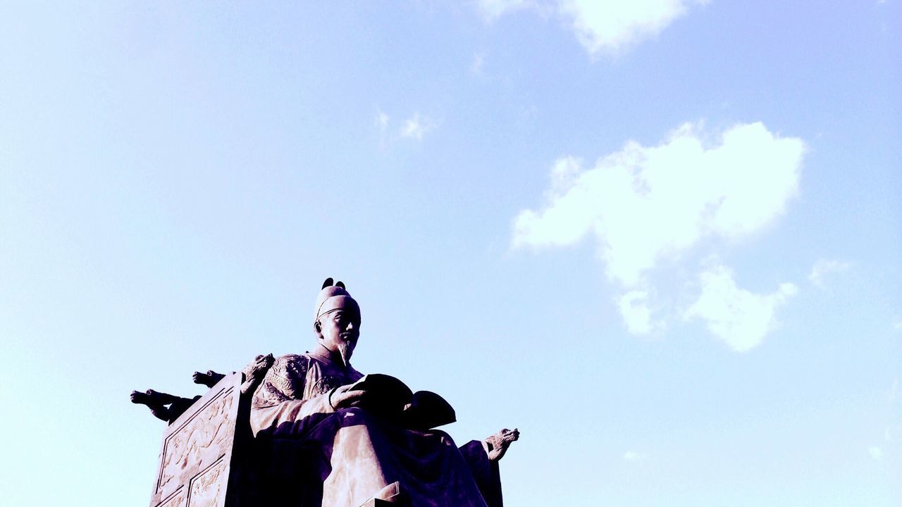 low angle view, sculpture, statue, human representation, art and craft, art, creativity, sky, animal representation, cloud - sky, blue, outdoors, craft, day, copy space, cloud, horse, no people