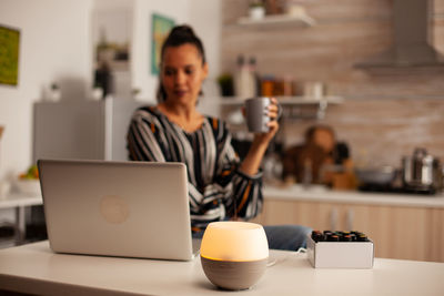 Woman using laptop at table