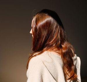 Back and profile of girl with red long hair 