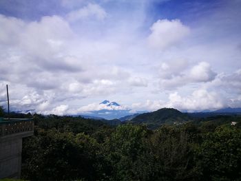 Scenic view of mountains against cloudy sky