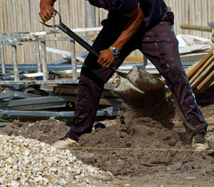 Low section of man working at construction site