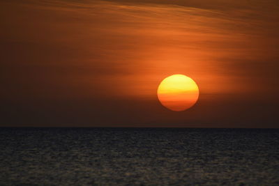 Scenic view of sea against romantic sky at sunset