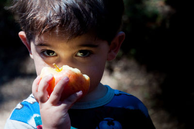 Close-up portrait of boy eating food