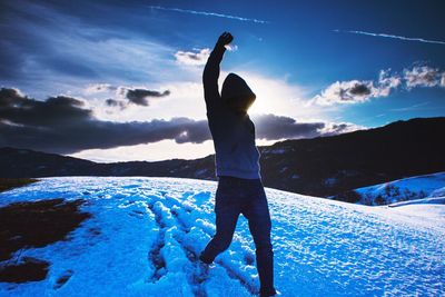 Man standing on mountain against sky