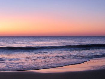 Scenic view of sea against clear sky during sunset