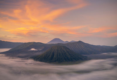 View of volcanic landscape against sunset sky