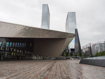 View of modern building against cloudy sky