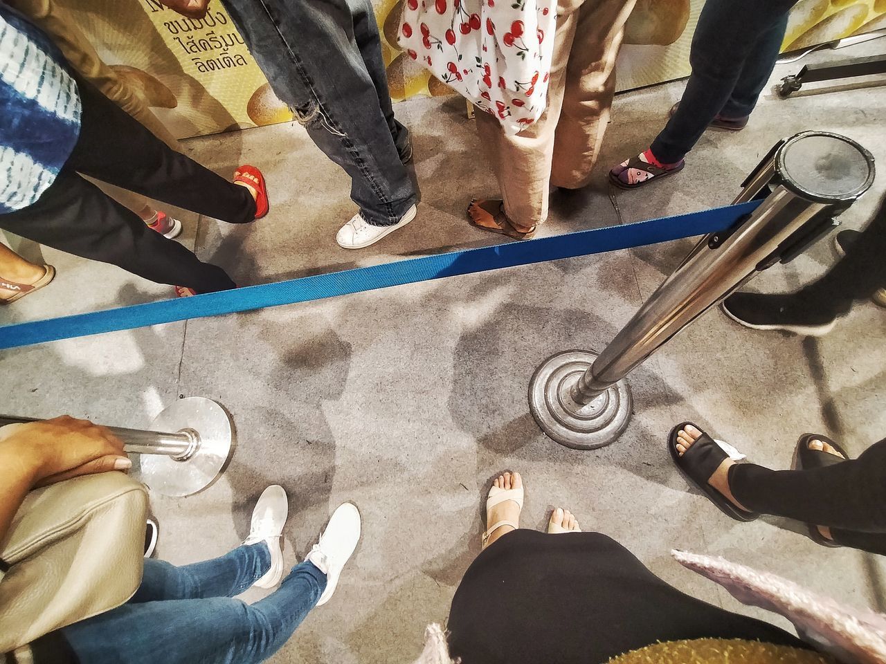 HIGH ANGLE VIEW OF PEOPLE STANDING ON FLOOR