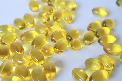 Close-up of yellow berries over white background