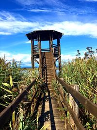 Lifeguard hut on field against sky