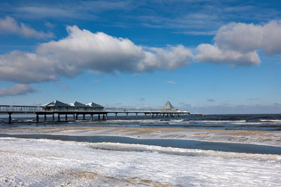 Pier over sea against sky