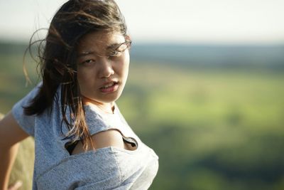 Portrait of young woman standing outdoors