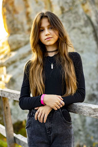 Portrait of young woman standing outdoors