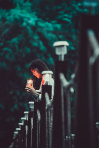 Young woman holding candle outdoors