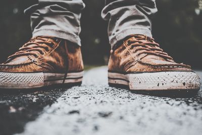 Low section of person wearing shoes standing on floor