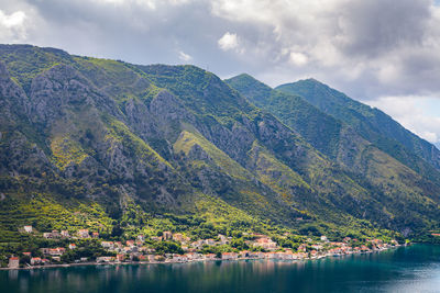 Scenic view of sea and mountains against sky