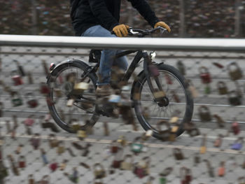 Low section of man riding bicycle on city