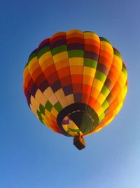 Low angle view of hot air balloon against clear blue sky
