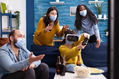 Cheerful woman playing game wearing virtual reality simulator