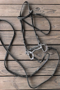 Close-up of bridle on wooden table