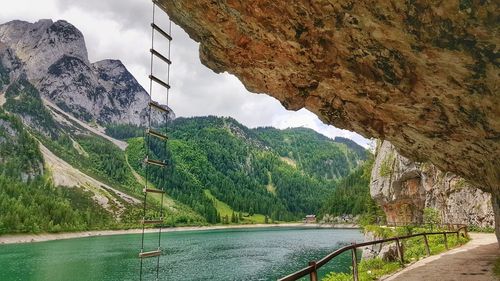 Scenic view of river and mountains against sky