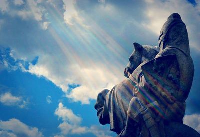 Low angle view of statue against cloudy sky