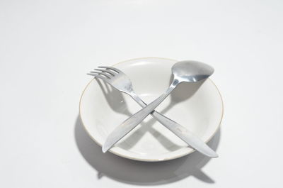 Close-up of wineglass against white background