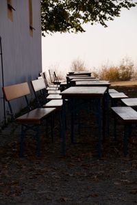 Empty chairs and table on field